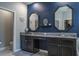 Bathroom featuring dual vanity sinks with granite countertops and dark blue walls at 21874 Crest Meadow Dr, Land O Lakes, FL 34637