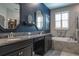 Bathroom featuring dual vanity sinks with granite countertops, a soaking tub, and a shower at 21874 Crest Meadow Dr, Land O Lakes, FL 34637