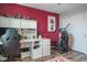 Bedroom features an exercise machine, white desk with storage, and a pink accent wall at 21874 Crest Meadow Dr, Land O Lakes, FL 34637
