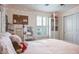 Cozy bedroom features white furniture, a canopy bed, and natural light from a window with shutters at 21874 Crest Meadow Dr, Land O Lakes, FL 34637