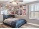Bedroom with a double bed, shuttered windows, ceiling fan, and anime art at 21874 Crest Meadow Dr, Land O Lakes, FL 34637