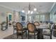 Dining room open to living room featuring a fireplace and television at 21874 Crest Meadow Dr, Land O Lakes, FL 34637