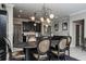 Open-concept dining room boasts stylish chandelier and seamless access to the kitchen at 21874 Crest Meadow Dr, Land O Lakes, FL 34637