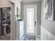 Inviting entryway featuring a stylish front door, decoratively tiled floor, and convenient access to a powder room at 21874 Crest Meadow Dr, Land O Lakes, FL 34637