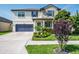 Charming two-story home with well-manicured lawn, lovely landscaping, and a welcoming front porch at 21874 Crest Meadow Dr, Land O Lakes, FL 34637