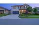 Charming two-story home with a manicured lawn and well-lit facade at 21874 Crest Meadow Dr, Land O Lakes, FL 34637