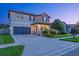 Inviting two-story home with manicured lawn and three car garage at 21874 Crest Meadow Dr, Land O Lakes, FL 34637