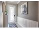 Welcoming foyer with wainscoting and tile flooring. A decorative rug sits inside the door at 21874 Crest Meadow Dr, Land O Lakes, FL 34637