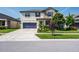 Charming two-story home with well-manicured lawn, lovely landscaping, and a welcoming front porch at 21874 Crest Meadow Dr, Land O Lakes, FL 34637
