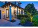 Charming front porch with columns, ceiling lights, and seating area with beautiful landscaping at 21874 Crest Meadow Dr, Land O Lakes, FL 34637