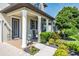 Charming front porch with white columns, hanging flower baskets, and rocking chairs at 21874 Crest Meadow Dr, Land O Lakes, FL 34637