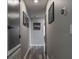 Clean and well lit hallway with gray walls, white trim and wood floors leads to other rooms at 21874 Crest Meadow Dr, Land O Lakes, FL 34637