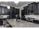 Spacious kitchen with granite countertops, stainless steel appliances, and sleek black cabinets at 21874 Crest Meadow Dr, Land O Lakes, FL 34637