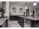 Bright and modern kitchen with built-in stainless steel dishwasher, gray cabinets, and an island at 21874 Crest Meadow Dr, Land O Lakes, FL 34637