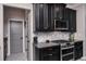 Kitchen with sleek black cabinets, marble backsplash, and stainless steel appliances at 21874 Crest Meadow Dr, Land O Lakes, FL 34637