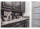 Close-up on a kitchen corner featuring granite countertops, and black cabinets at 21874 Crest Meadow Dr, Land O Lakes, FL 34637