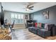 Inviting living room features wood floors, gray accent wall and natural light from a window with plantation shutters at 21874 Crest Meadow Dr, Land O Lakes, FL 34637