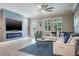 Living room featuring a fireplace, a TV, and a comfortable-looking sofa at 21874 Crest Meadow Dr, Land O Lakes, FL 34637