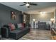 Comfortable living room boasts a black sectional sofa, wood floors, and a view of an antique cabinet at 21874 Crest Meadow Dr, Land O Lakes, FL 34637