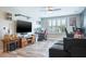Living room with shuttered windows, wood-look flooring, and a comfortable couch at 21874 Crest Meadow Dr, Land O Lakes, FL 34637
