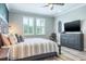 View of the main bedroom with an accent chair, dresser, and wood-look flooring at 21874 Crest Meadow Dr, Land O Lakes, FL 34637