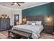 Spacious main bedroom featuring a decorative headboard, a patterned accent wall, and wood-look floors at 21874 Crest Meadow Dr, Land O Lakes, FL 34637