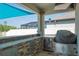 Outdoor kitchen and bar area with built in stainless steel grill and beverage cooler at 21874 Crest Meadow Dr, Land O Lakes, FL 34637