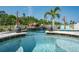 Stunning pool and spa with rock waterfall, set amongst beautiful landscaping and lush greenery at 21874 Crest Meadow Dr, Land O Lakes, FL 34637