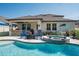 Backyard pool featuring a spa, an outdoor kitchen, a fire pit and lush landscaping at 21874 Crest Meadow Dr, Land O Lakes, FL 34637
