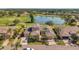 Expansive aerial view of the home, showcasing its scenic surroundings by the pond and golf course at 2407 Kensington Greens Dr, Sun City Center, FL 33573