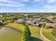 Overhead view of house near lake and golf course showcasing community layout at 2407 Kensington Greens Dr, Sun City Center, FL 33573