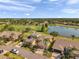 Aerial view of a home overlooking a golf course and peaceful lake at 2407 Kensington Greens Dr, Sun City Center, FL 33573