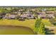 Drone shot displays lake view and well-maintained home and lawn at 2407 Kensington Greens Dr, Sun City Center, FL 33573