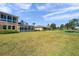 Exterior view of homes featuring a sunroom, set against a backdrop of lush greenery at 2407 Kensington Greens Dr, Sun City Center, FL 33573