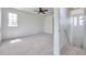 Spacious bedroom with a ceiling fan and lots of light, with a view of the upstairs landing at 2407 Kensington Greens Dr, Sun City Center, FL 33573