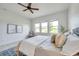 Serene bedroom featuring neutral tones, decorative artwork, and natural light at 2407 Kensington Greens Dr, Sun City Center, FL 33573