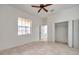 Neutral bedroom with tiled floors, ceiling fan, and natural light at 2407 Kensington Greens Dr, Sun City Center, FL 33573