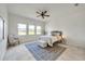Airy bedroom featuring a cozy rug, neutral tones, and sunny windows at 2407 Kensington Greens Dr, Sun City Center, FL 33573