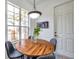 Sunlit dining area features a round table and a large window with natural light at 2407 Kensington Greens Dr, Sun City Center, FL 33573