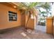 Exterior entry area with brick pavers, a small palm tree, and a protected entryway at 2407 Kensington Greens Dr, Sun City Center, FL 33573
