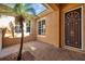 Exterior view with palm tree, security door, and brick paved ground in a private courtyard at 2407 Kensington Greens Dr, Sun City Center, FL 33573