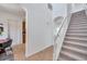 Bright foyer with tile floors and staircase leading to the upper level of the home at 2407 Kensington Greens Dr, Sun City Center, FL 33573