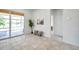 Bright entryway featuring neutral tile flooring, leading to a sunroom and interior rooms at 2407 Kensington Greens Dr, Sun City Center, FL 33573