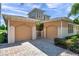 Stunning home with a two-car garage, brick driveway, and well-maintained landscaping at 2407 Kensington Greens Dr, Sun City Center, FL 33573