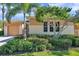 Charming home exterior with a well-manicured lawn and lush shrubbery at 2407 Kensington Greens Dr, Sun City Center, FL 33573
