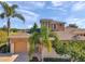 Beautiful home with a well-kept lawn, palm trees, and a charming facade at 2407 Kensington Greens Dr, Sun City Center, FL 33573