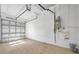 Bright garage featuring garage door, water heater and utility sink in a clean space at 2407 Kensington Greens Dr, Sun City Center, FL 33573