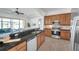 Beautiful kitchen featuring stainless appliances, dark countertops and a view of the lake at 2407 Kensington Greens Dr, Sun City Center, FL 33573