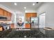 Modern kitchen featuring stainless steel appliances and sleek black granite countertops at 2407 Kensington Greens Dr, Sun City Center, FL 33573