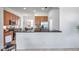 Kitchen featuring wood cabinets, stainless steel appliances, and a breakfast bar overlooking a dining area at 2407 Kensington Greens Dr, Sun City Center, FL 33573